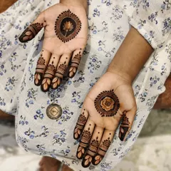 Another beautiful option for bridesmaids, this design has a lotus motif on one hand and a rose on the other, with matching finger details.