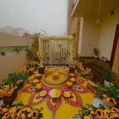 There's nothing like the energy of a Haldi ceremony. This outdoor setup features a hand-painted floor mandala and a canopy of fresh white and yellow flowers, creating a vibrant and picture-perfect space for the celebration.