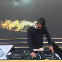 In my element at a daytime wedding event. A clear shot of my professional Pioneer DJ console against a vibrant backdrop shows my commitment to quality sound and a seamless musical experience.