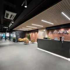 A full view of the reception and entrance, showcasing the clean lines, integrated lighting, and a material palette that reflects a modern, design-forward company.