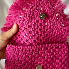 The inside of my sling bag shows the magnetic button I use to keep your things safe. It's small but surprisingly spacious for your phone, keys, and a little notebook.