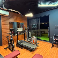 This corner of the gym is dedicated to cardio, with a treadmill and elliptical machine. The large UPVC sliding doors open up to the outdoor lounge, letting in natural light and providing a great view during a workout.
