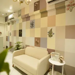 The waiting area in our clinic is designed for your comfort. The soft color palette and botanical details create a tranquil atmosphere, helping you unwind before your treatment begins.