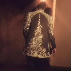 The back of this jacket is just as stunning as the front. This shot highlights the beautiful embroidery that flows down the spine, ensuring a dramatic exit.