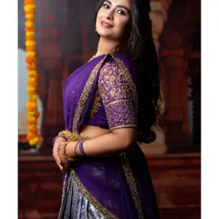 A beautiful portrait in the purple half-saree, showing the detailed embroidery on the blouse sleeves.