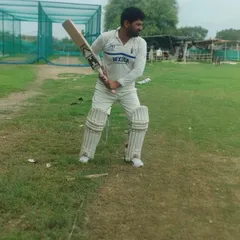 A batsman ready at the crease, showcasing a solid stance and balance. Getting this starting position right is the foundation of every good shot.