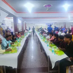 Our team serving a large gathering at ANR Bhavan in Kasturinagar. The long tables are set for a traditional banana leaf meal, showcasing our ability to manage large-scale wedding catering.