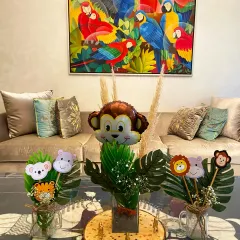 Welcome to the jungle. This adorable animal-themed table setup is perfect for a little one's party. We used cute animal cutouts, monstera leaves, and a cheeky monkey foil balloon to create fun and wild centerpieces that kids absolutely love.