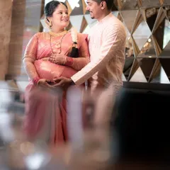 A wider portrait of the couple during their ceremony, showing their loving interaction. The elegant decor and their traditional attire are beautifully framed, capturing the essence of their special day.