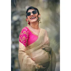 Pure joy and excitement. This portrait of a radiant mother-to-be, laughing and stylish in her sunglasses and saree, perfectly captures the happiness of pregnancy.