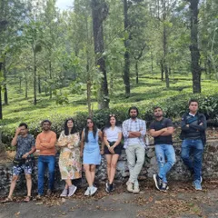 Our group from the Valparai trip, posing together in the middle of a beautiful, tree-lined road. It's these shared moments in beautiful places that build lasting friendships.