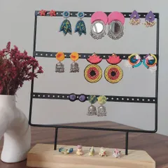 A display of the variety of earrings I create. You can see everything from large mirror work chandbalis and colorful jhumkis to hand-painted studs, all handmade by me.