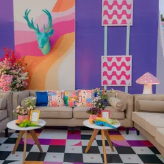 I created vibrant and comfortable lounge areas that combined eclectic patterns, bold colors, and whimsical props. This space shows a mix of checkerboard floors, patterned cushions, and quirky animal sculptures, ensuring every corner was visually stimulating.