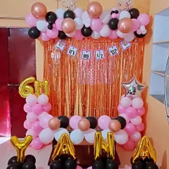 A full view of the 6-month birthday decoration. The setup includes balloon pillars, a balloon arch, and foil balloons indicating the milestone.