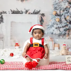 A little one's first Christmas. My festive mini sessions include adorable Santa outfits and a winter wonderland setup to capture this special milestone.