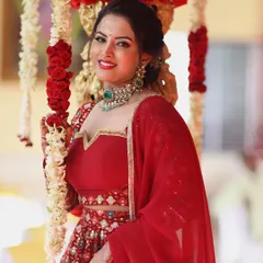 This shot showcases the beautiful neckline and dupatta of the red embroidered lehenga, a perfect rental for a bride.