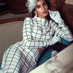 Inspired by vintage fashion, this look is pure elegance. The checked co-ord set, classic white gloves, and a delicate fascinator come together to create a timeless and sophisticated outfit reminiscent of derby fashion.