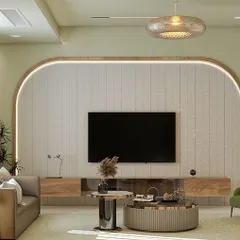 This living room design uses a soft, neutral color palette with pops of green to create a calming effect. The arched feature wall with integrated lighting elegantly frames the entertainment unit, making it a central design element.