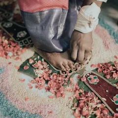 A close-up of a bride's feet during the toe ring ceremony, a significant ritual in many South Indian weddings. I focus on these details to tell a complete wedding story.