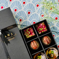 An overhead view of our beautifully arranged Malcha Box, showcasing the variety and artistry of our modern Indian sweets. Each piece is a bite-sized delight, perfect for festive celebrations.