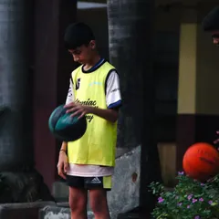 A young player focuses on the ball before a drill. This quiet moment of concentration is where the mental game begins.