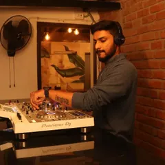In the zone, mixing tracks. This is my workspace, whether it's in a studio or a packed club. The focus is always on creating a seamless flow of music.