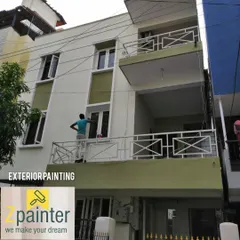 Painting the exterior of a multi-level home. You can see one of my painters carefully working on the balcony wall, demonstrating our attention to detail.