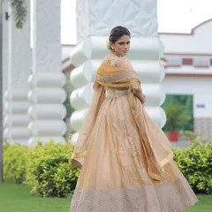 Back and side views of the custom golden lehenga, showing its beautiful silhouette and the delicate organza dupatta.