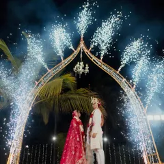 A moment of pure cinematic magic. We framed the couple's union under a grand arch, brought to life with a spectacular display of cold pyrotechnics. This design element adds a burst of excitement and grandeur, ensuring the wedding photos are as dramatic and memorable as the moment itself.
