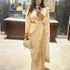 A mirror selfie capturing the side-drape of the zardozi dupatta over the powersuit, highlighting the unique silhouette.