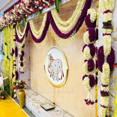 A side view of our cow-themed decor, highlighting the thick, lush garlands made of purple and white flowers. The intricate floral work adds a touch of grandeur to the setup.