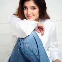 A closer crop for a more intimate portrait. This shot highlights the model's expressive eyes and friendly demeanor, making for a strong and engaging headshot.