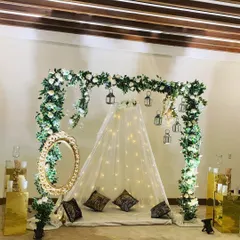 This elegant floor seating arrangement is one of my most versatile designs, ideal for an anniversary or a romantic surprise. I used a canopy of fairy lights, an arch of white roses and greenery, and hanging lanterns to create a dreamy, picture-perfect photo corner.