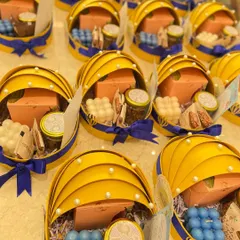 A closer look at the contents of our baby announcement hampers. We include items like bubble candles, gourmet snacks, and personalized cards to make the announcement extra special.