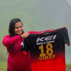An RCB fan proudly displays a Virat Kohli jersey during our Netravathi trek. The cricket fever is real, even in the mountains.