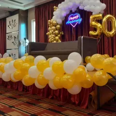 Another angle of the 50th anniversary decor, showing the beautiful contrast between the golden balloons and the white balloon cloud effect.