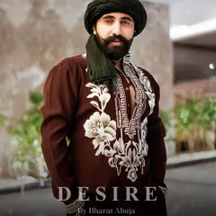 Power in subtlety. This deep maroon kurta is elevated by bold, contrasting ivory embroidery that frames the neckline and cuffs. It is a design that speaks of heritage and sophistication, tailored for a commanding presence.