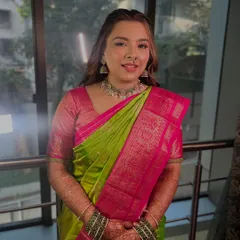 A full-length view of the engagement look, showing how the soft makeup complements the bright, festive saree.