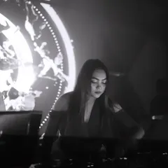 A moody black and white shot of me focused on the mix, with artistic visuals in the background.
