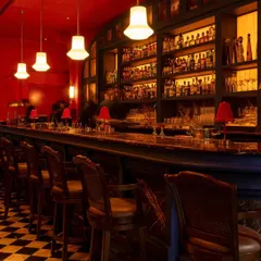 The main bar, a centerpiece of the design. Its form is inspired by traditional Thai architecture, while the extensive back bar and classic stools invite patrons to settle in for the evening.