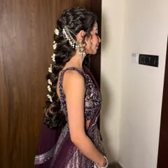 A side view of this intricate braid, showing how the accessories are woven into the hair for a secure and beautiful finish.