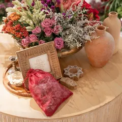 This beautiful and intricate floral decor ties every detail together. The centerpiece, featuring a mix of colorful blooms and textures, is complemented by terracotta pots and wooden block prints, making the "Garden of Vows" affair truly breathtaking.