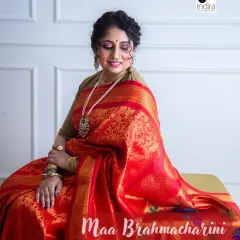 For Day 2 of the Navdurga series, this radiant red Banarasi saree symbolizes Devi Brahmacharini's devotion and strength. The soft lighting and seated pose create a feeling of serene contemplation, highlighting the rich texture of the silk.