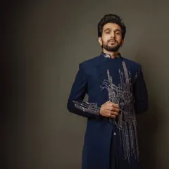 Pratik Gandhi shows that sharp looks, effortless charm, and undeniable confidence are a lethal combination. He wears a custom navy bandhgala with silver embroidery.