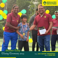 A proud moment as a summer camp participant receives his completion certificate and medal from our coaches.