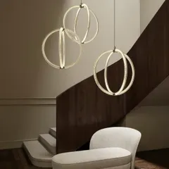 Three Luminora pendants by Moooi descend gracefully through a minimalist staircase, their interlocking rings creating a captivating geometric display. This installation highlights how I use modern, sculptural lighting to enhance architectural features and create a sense of movement and elegance in transitional spaces.