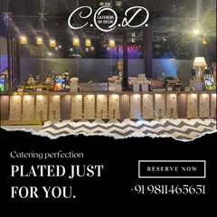 A full view of our buffet setup for an evening event, with hanging lights creating a warm and inviting atmosphere. The long, illuminated counter is meticulously arranged to ensure a smooth flow for guests.
