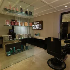 This is one of our dedicated men's grooming stations. It is fully equipped with premium products and tools, set within a space that feels both exclusive and comfortable.