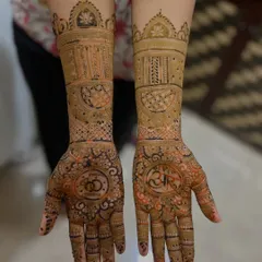 A perfect design for an engagement. This mehendi features the couple's initials 'A' and 'R' inside circles on the palms, along with a drawing of interlocking rings to symbolize their union.