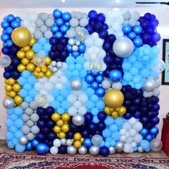 A coustamised balloon wall decoration in shades of blue, silver, and gold. This makes for an incredible photo backdrop and adds a major wow factor to any event.